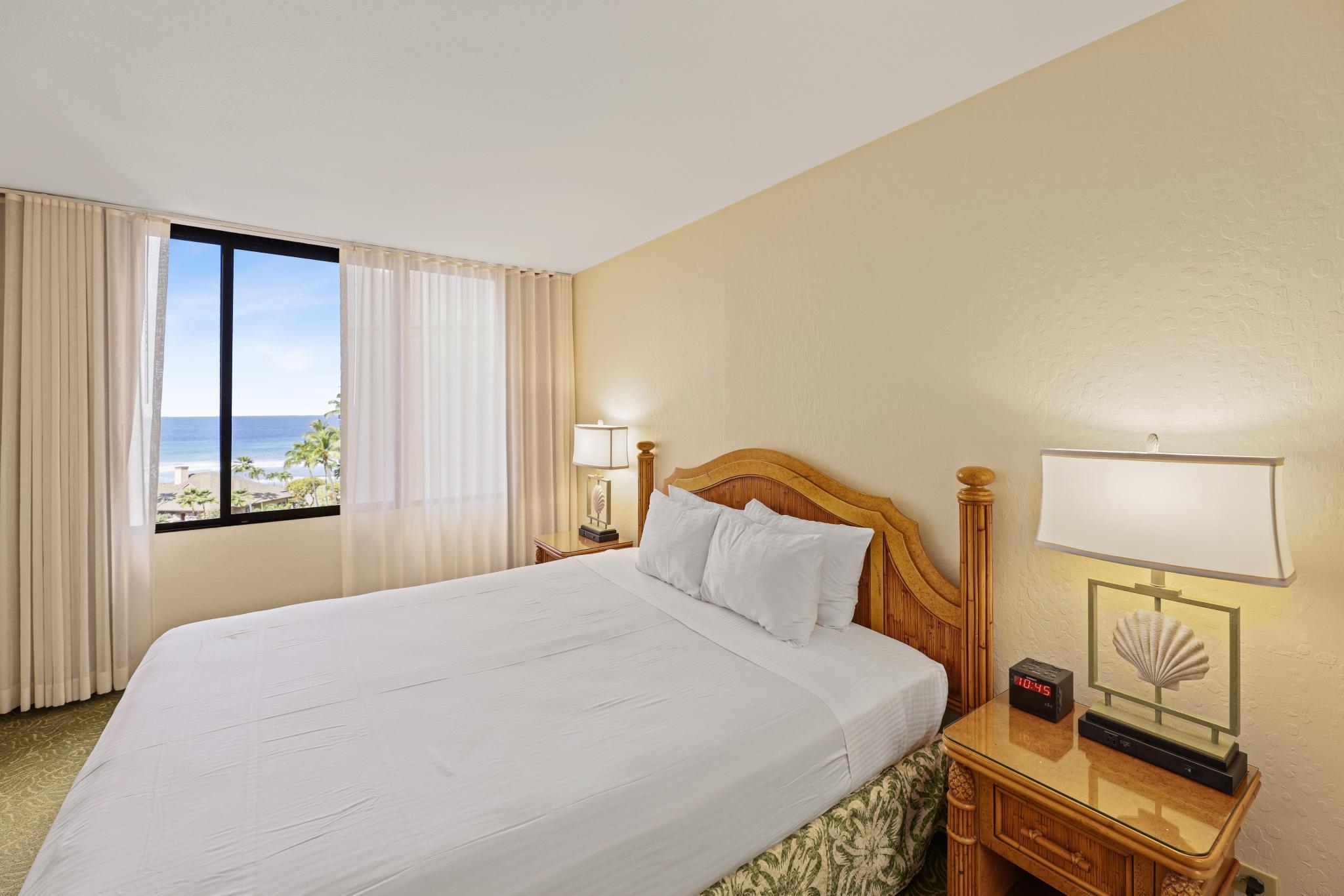 3445 Lower Honoapiilani Road, Unit 727 Lahaina, HI 96761 - Photo 18 of 42 a bedroom with a bed and wooden floor