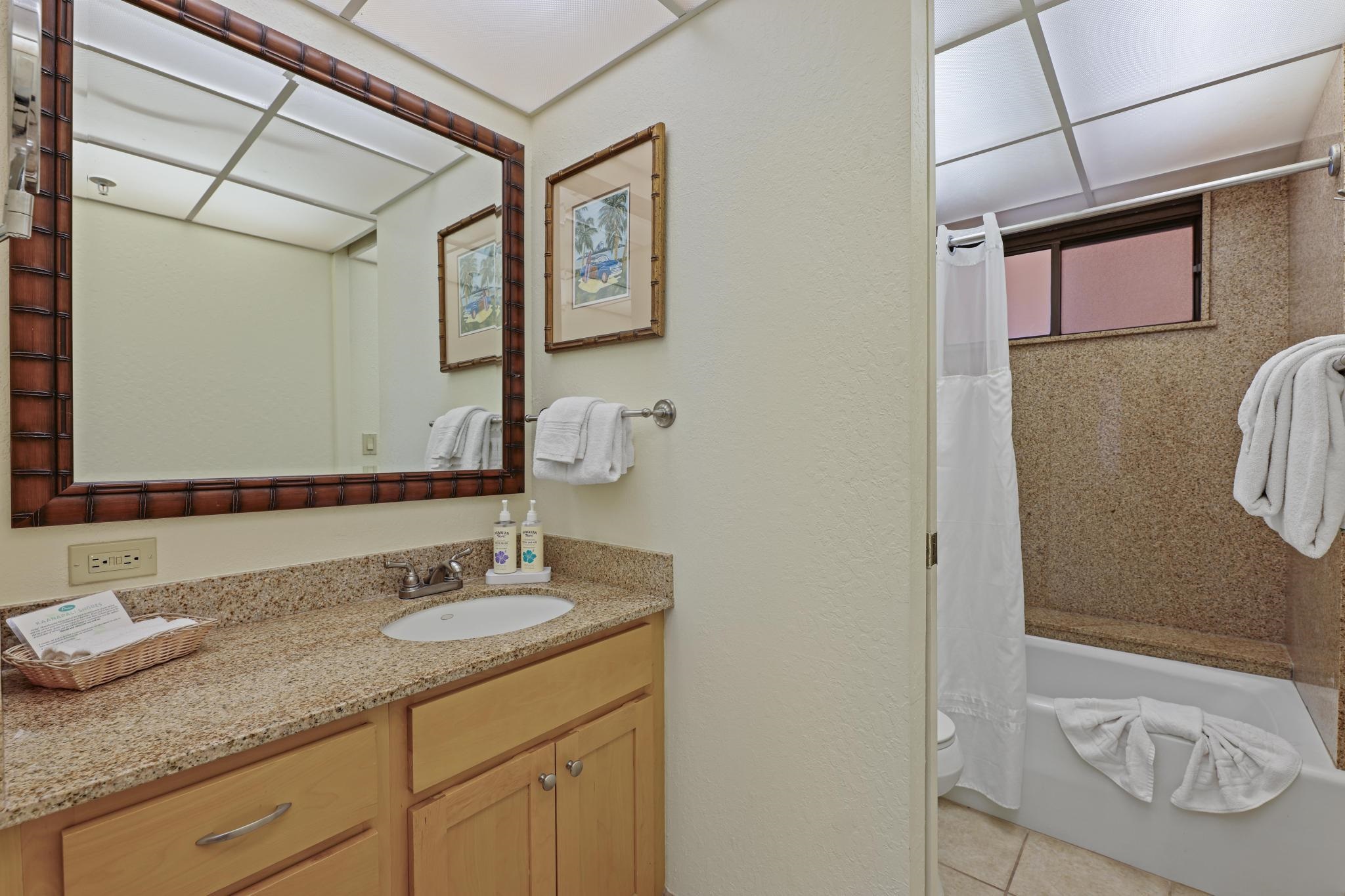 3445 Lower Honoapiilani Road, Unit 727 Lahaina, HI 96761 - Photo 20 of 42 a bathroom with a granite countertop sink and a mirror