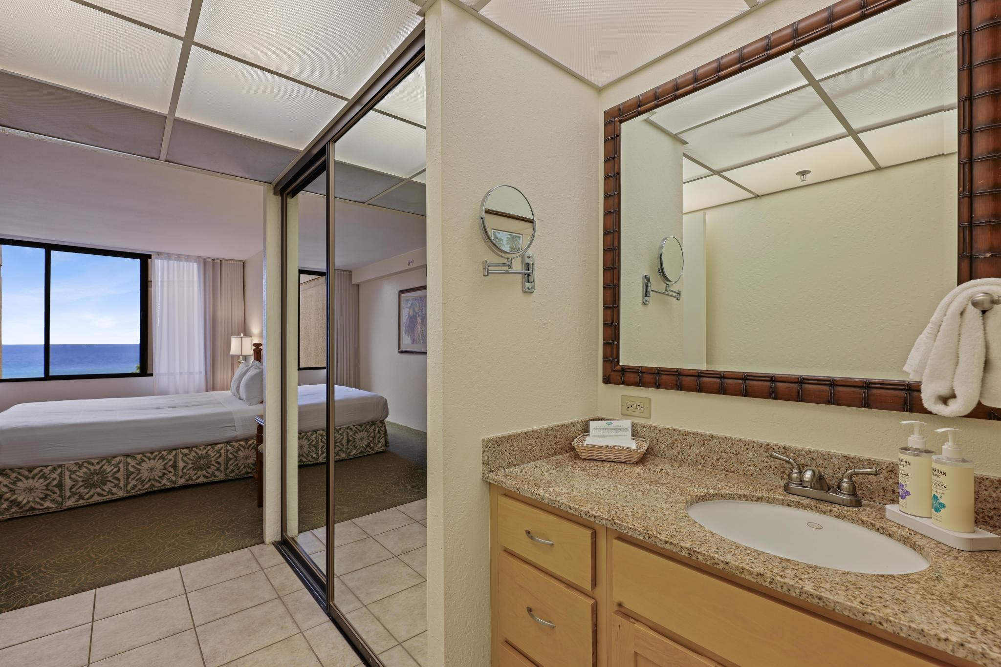 3445 Lower Honoapiilani Road, Unit 727 Lahaina, HI 96761 - Photo 25 of 42 a en suite bathroom with a granite countertop sink and a mirror