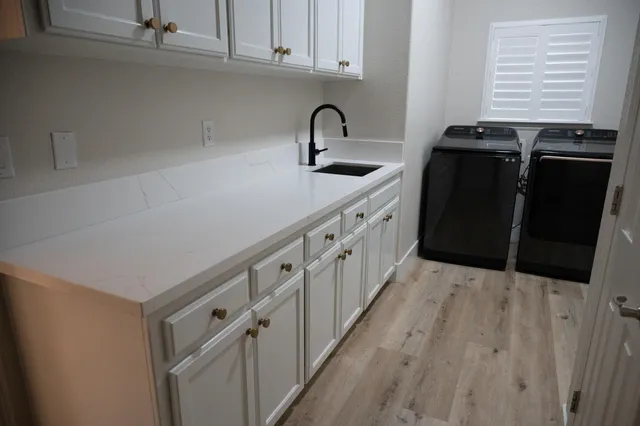 a kitchen with granite countertop white cabinets and black appliances