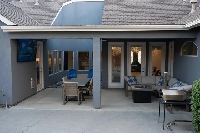 a building outdoor space with patio furniture and potted plants