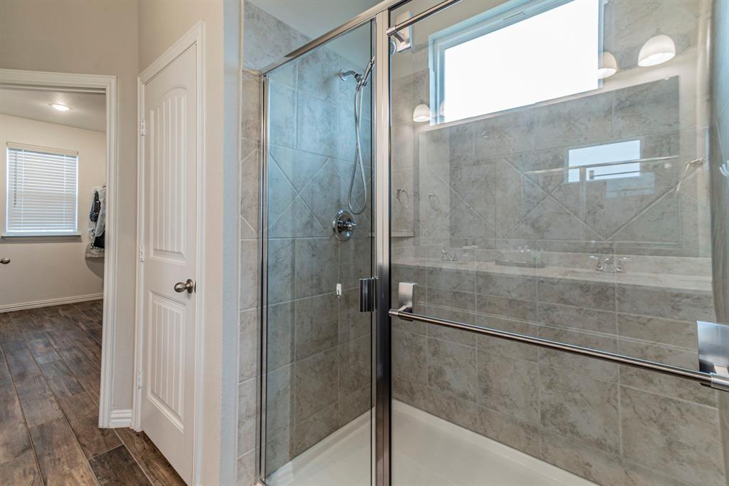 8432 Abner Road Terrell, TX 75161 - Photo 12 of 33 a bathroom with a glass shower door