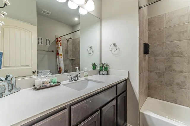 a bedroom with a bed table and chair