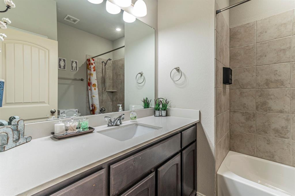 8432 Abner Road Terrell, TX 75161 - Photo 14 of 33 a bathroom with a granite countertop sink a large mirror and shower