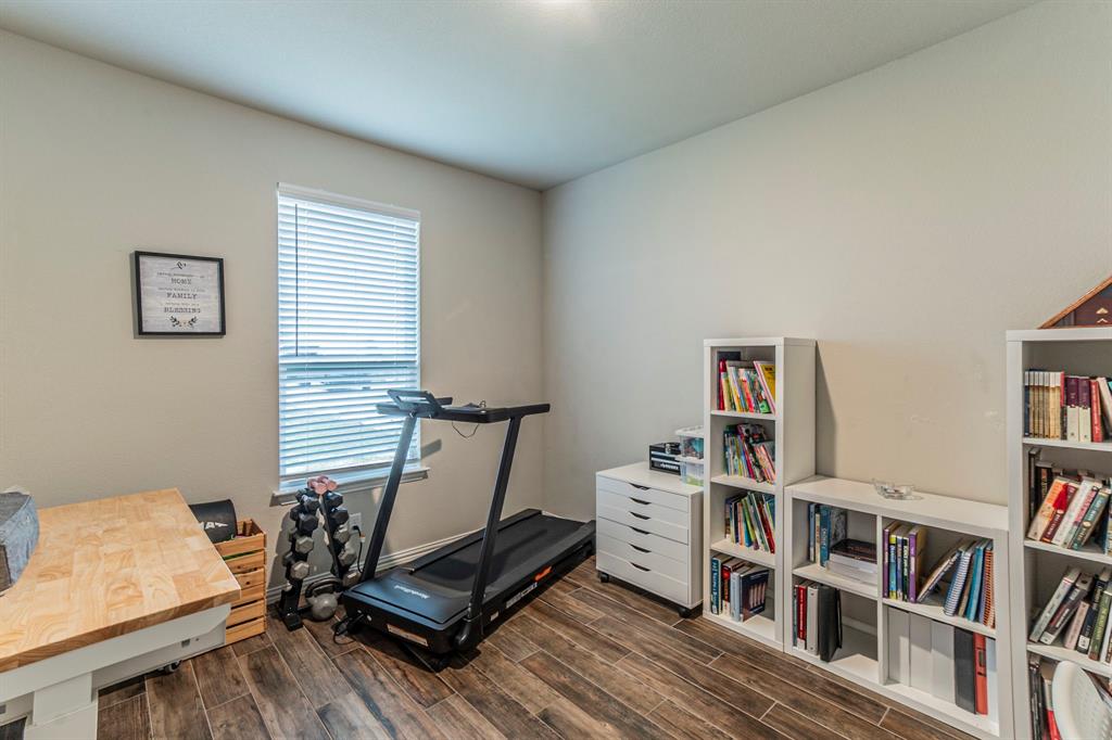 8432 Abner Road Terrell, TX 75161 - Photo 16 of 33 a living room with furniture and a book shelf