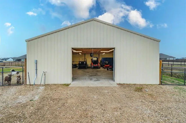 a view of a garage with a bike and white car