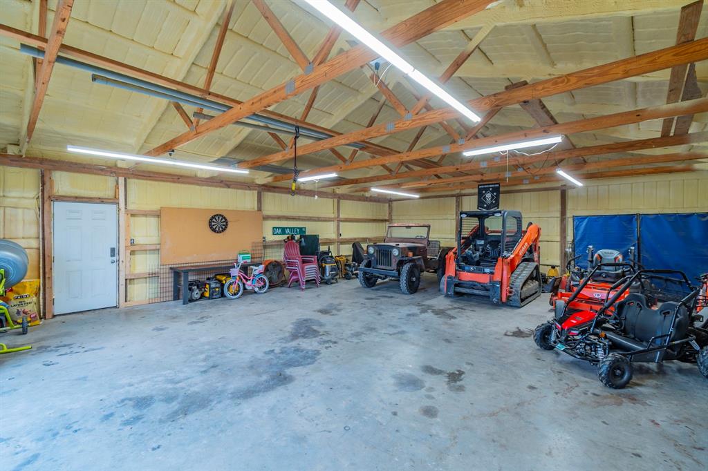 8432 Abner Road Terrell, TX 75161 - Photo 22 of 33 a view of a garage with a bike and white car