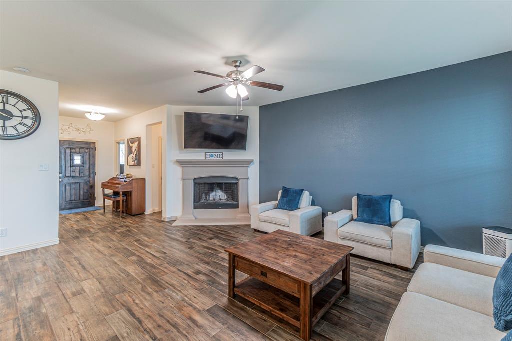 8432 Abner Road Terrell, TX 75161 - Photo 4 of 33 a living room with furniture and a fireplace