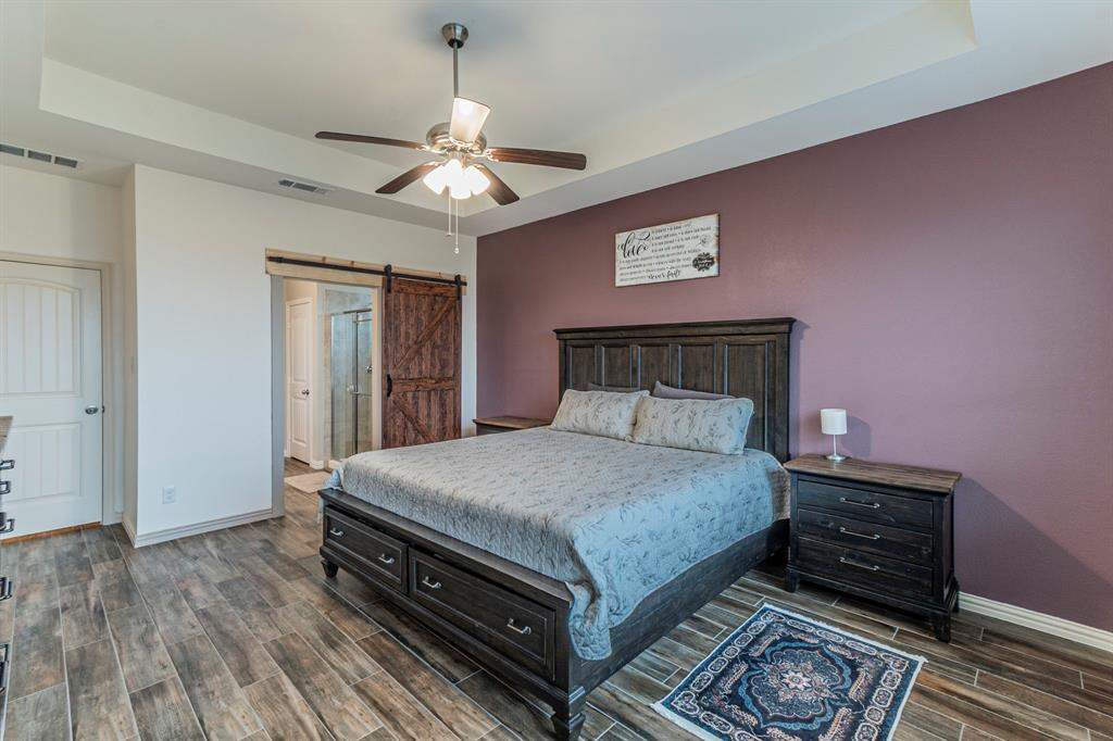 8432 Abner Road Terrell, TX 75161 - Photo 10 of 33 a bedroom with a bed and wooden floor