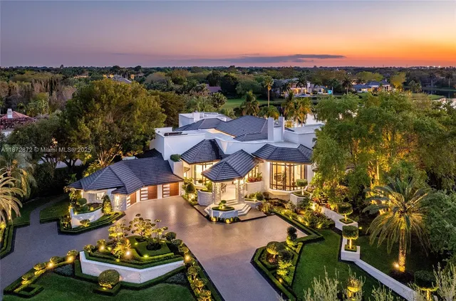 an aerial view of a houses with a swimming pool and outdoor seating
