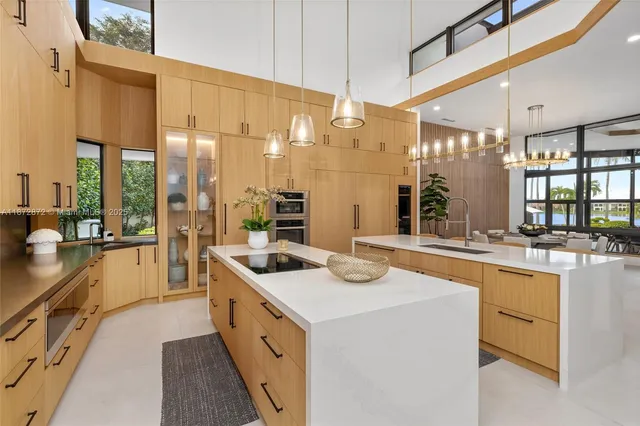 a large white kitchen with a large window