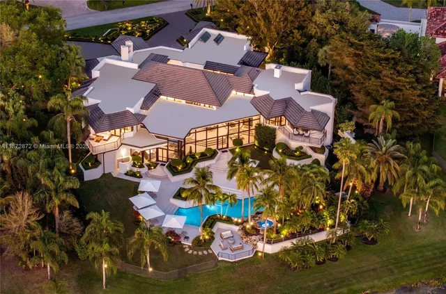 an aerial view of residential houses with outdoor space and swimming pool