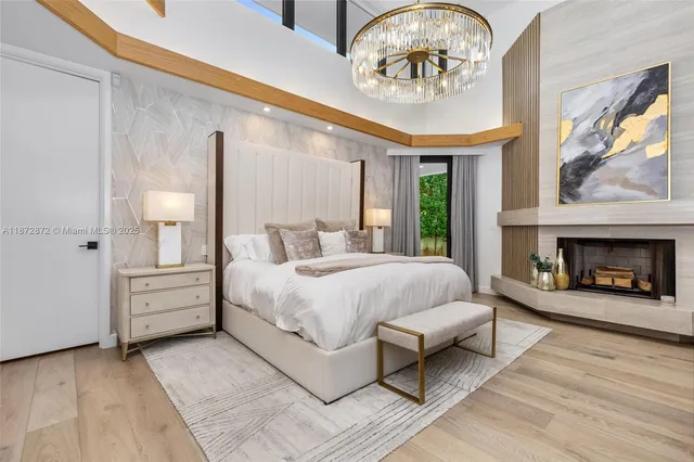 a bedroom with a bed and a chandelier