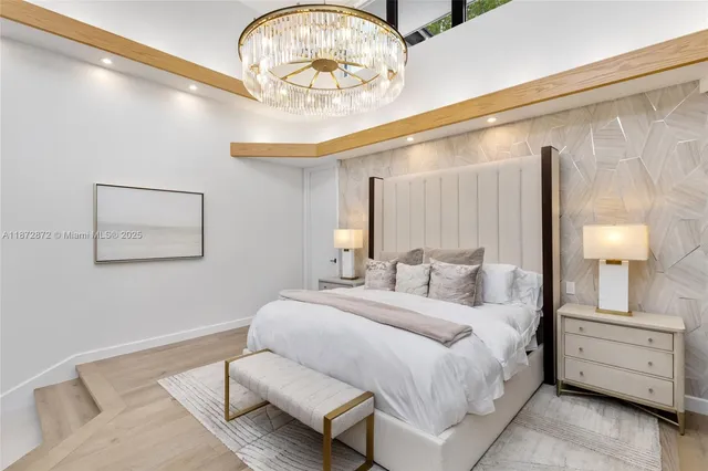 a bedroom with a large bed and a large window