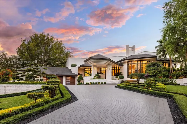 a front view of a house with a yard table and chairs