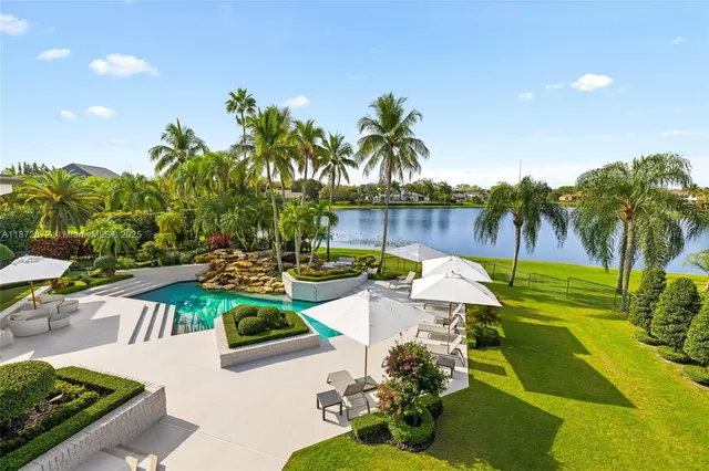an aerial view of a house with swimming pool garden and patio