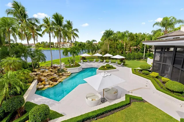 a swimming pool with outdoor seating and yard