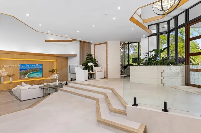 a living room with furniture and large windows