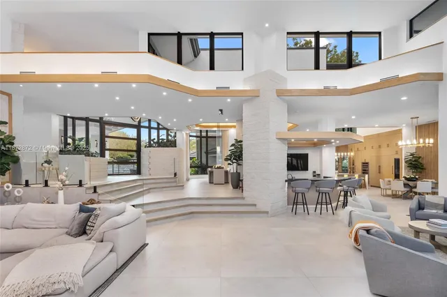 a living room with furniture and a large mirror