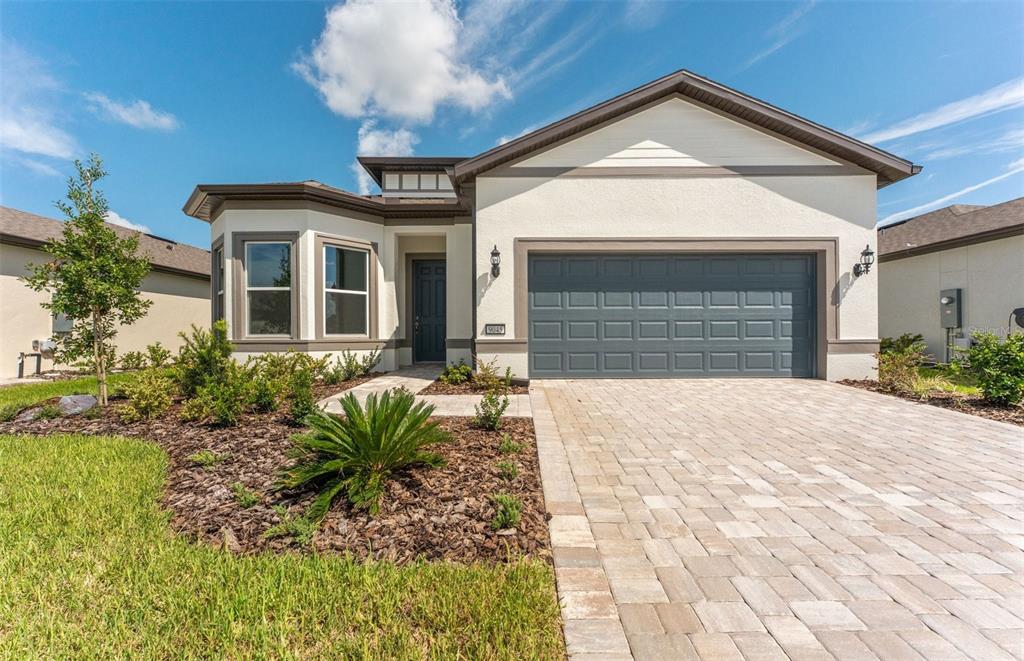 9045 Southwest 52nd Pl Road Ocala, FL 34481 - Photo 1 of 1 a front view of a house with garden