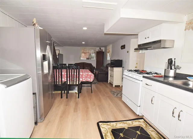 a kitchen with a sink appliances and cabinets
