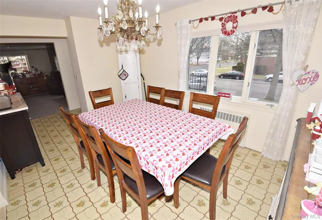 a view of a dining room with furniture and chandelier