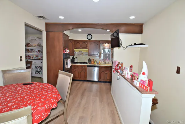 a kitchen with stainless steel appliances kitchen island granite countertop a sink and cabinets
