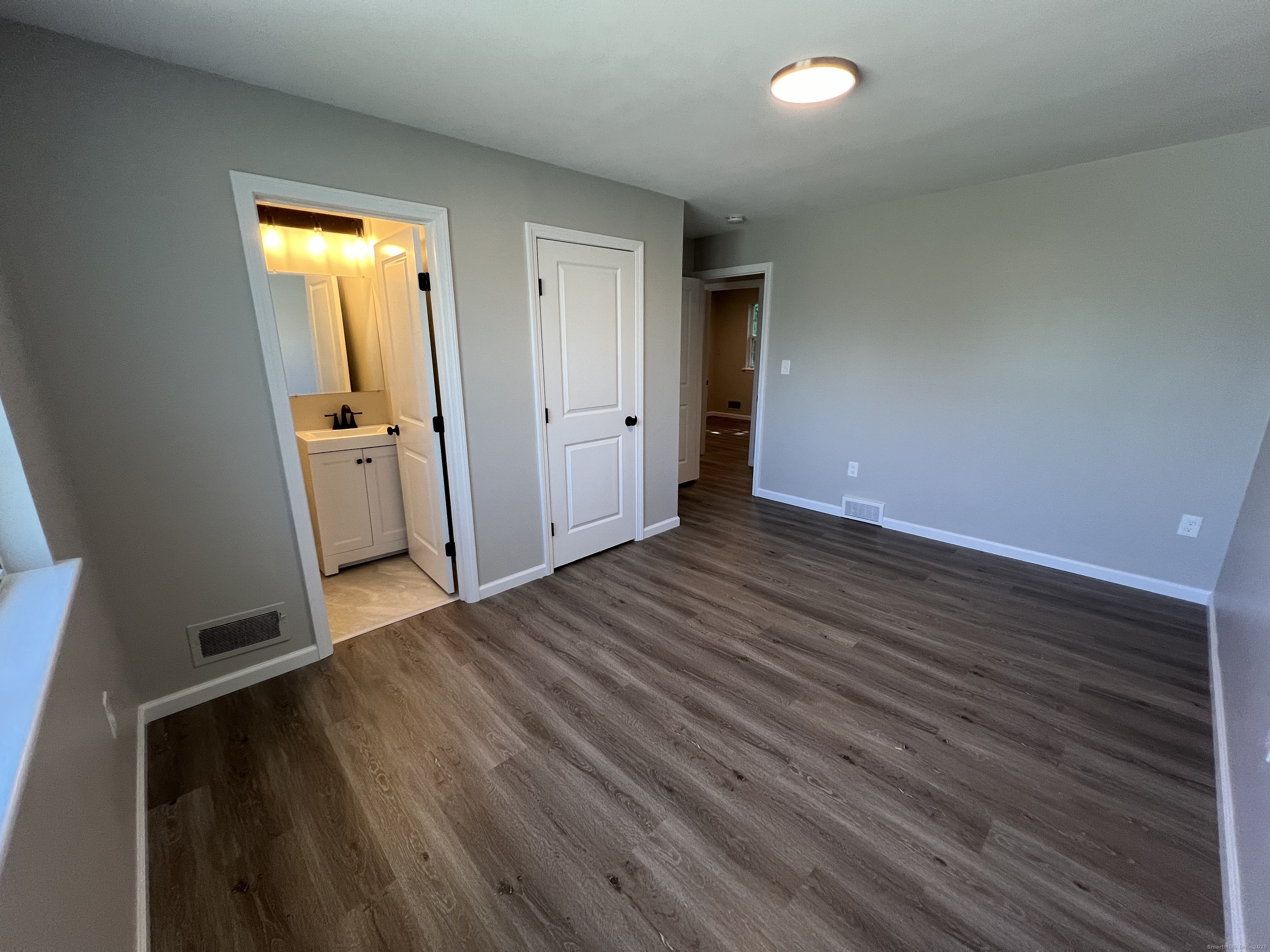 111-113 Sunset Avenue Meriden, CT 06450 - Photo 11 of 25 an empty room with wooden floor and entrance