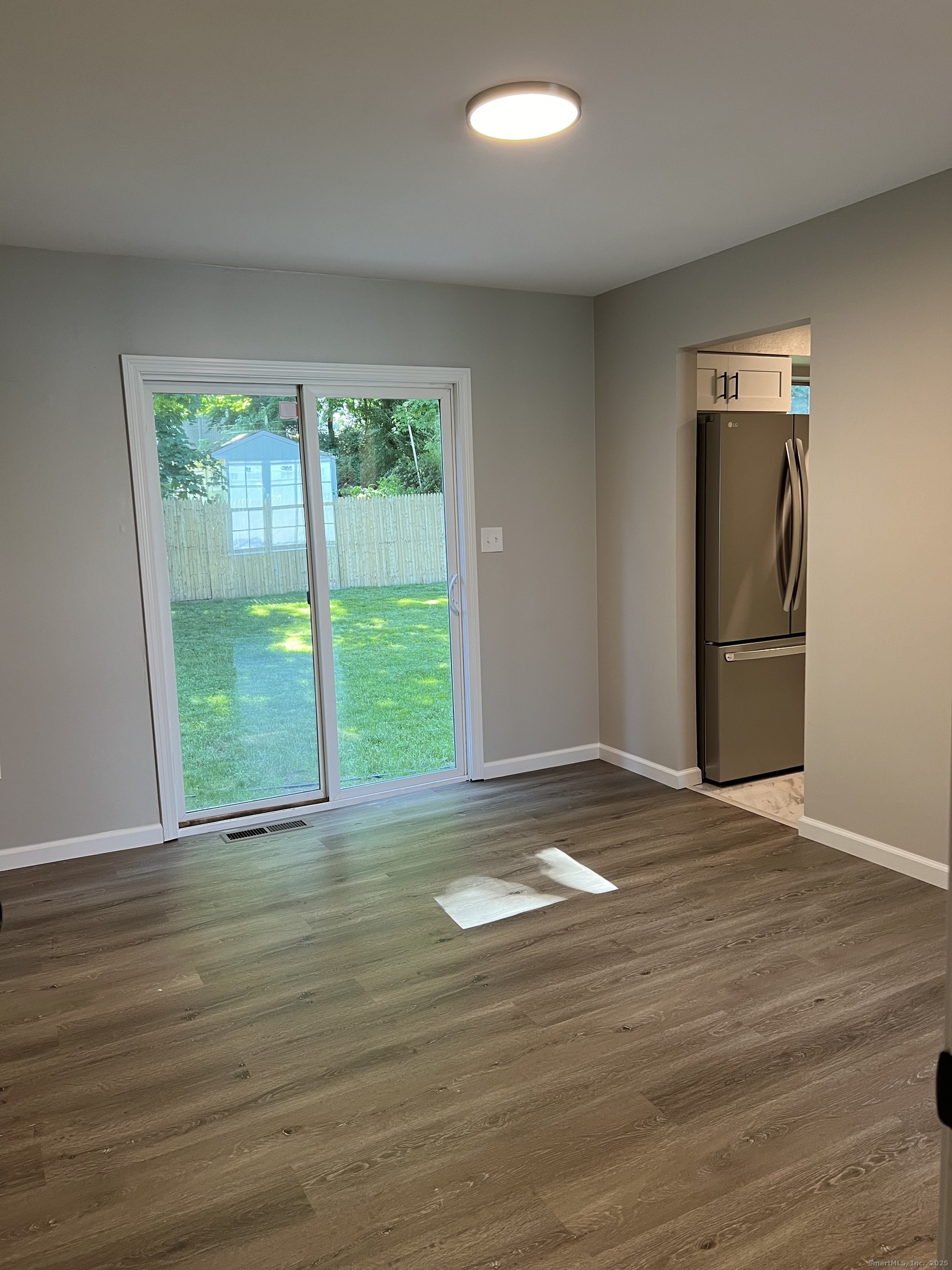 111-113 Sunset Avenue Meriden, CT 06450 - Photo 17 of 25 a view of an empty room with wooden floor and a window