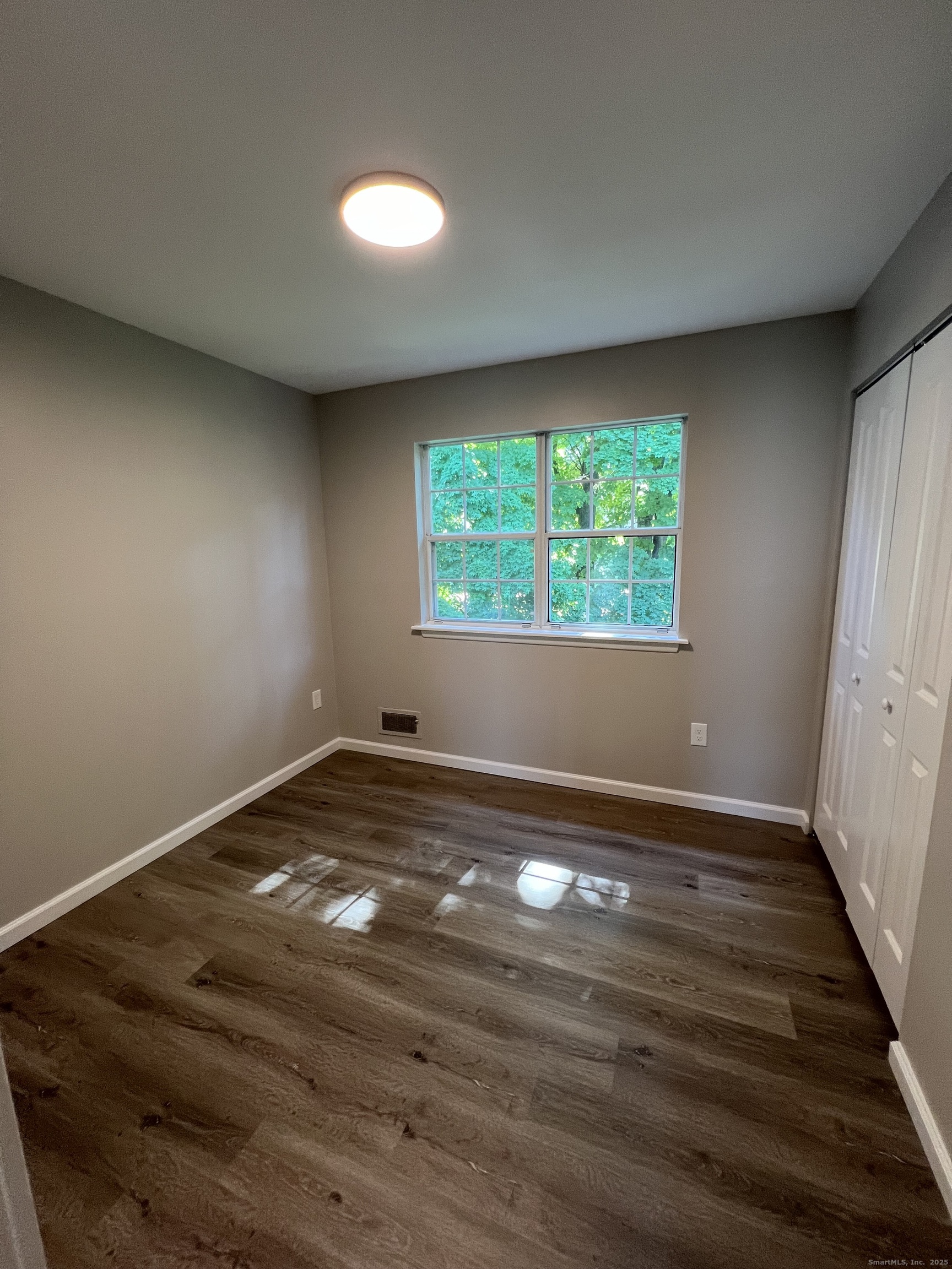 111-113 Sunset Avenue Meriden, CT 06450 - Photo 17 of 25 an empty room with wooden floor and windows
