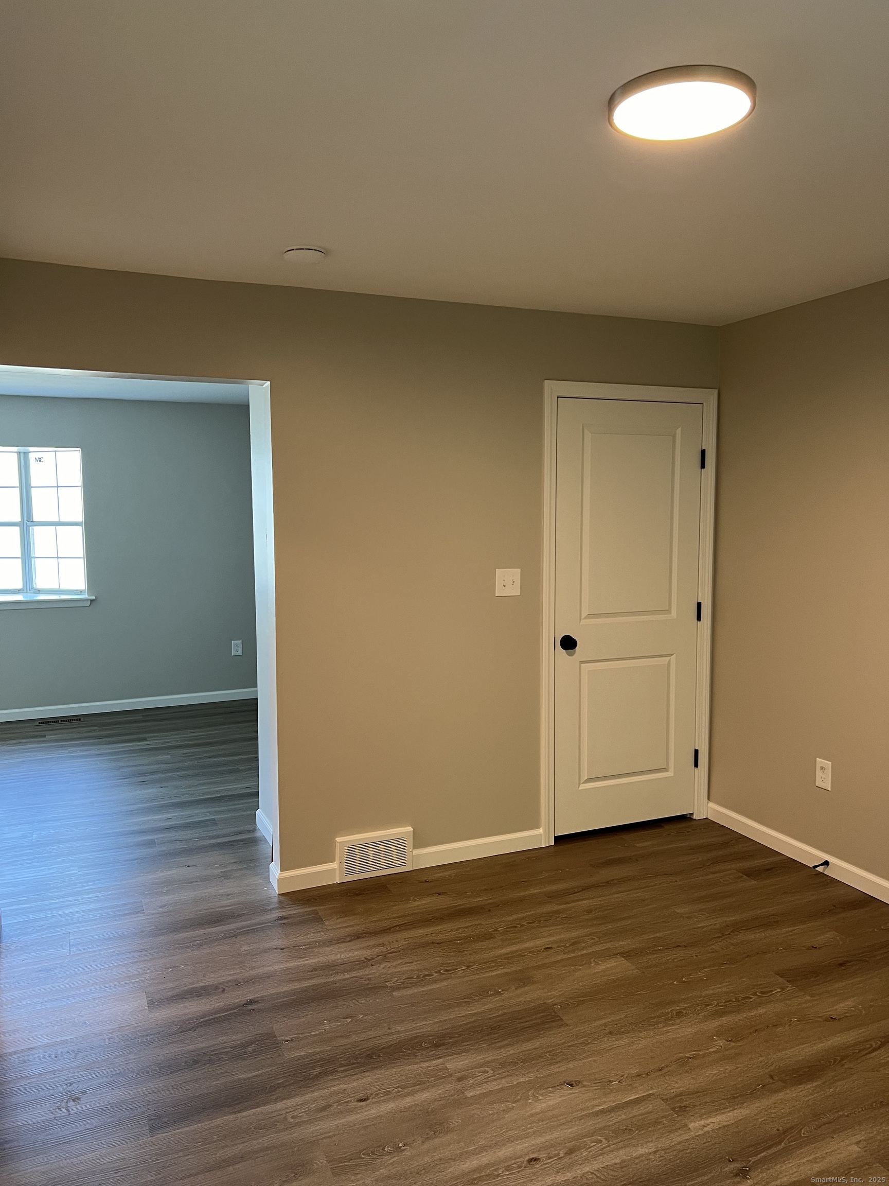 111-113 Sunset Avenue Meriden, CT 06450 - Photo 18 of 25 an empty room with wooden floor and windows