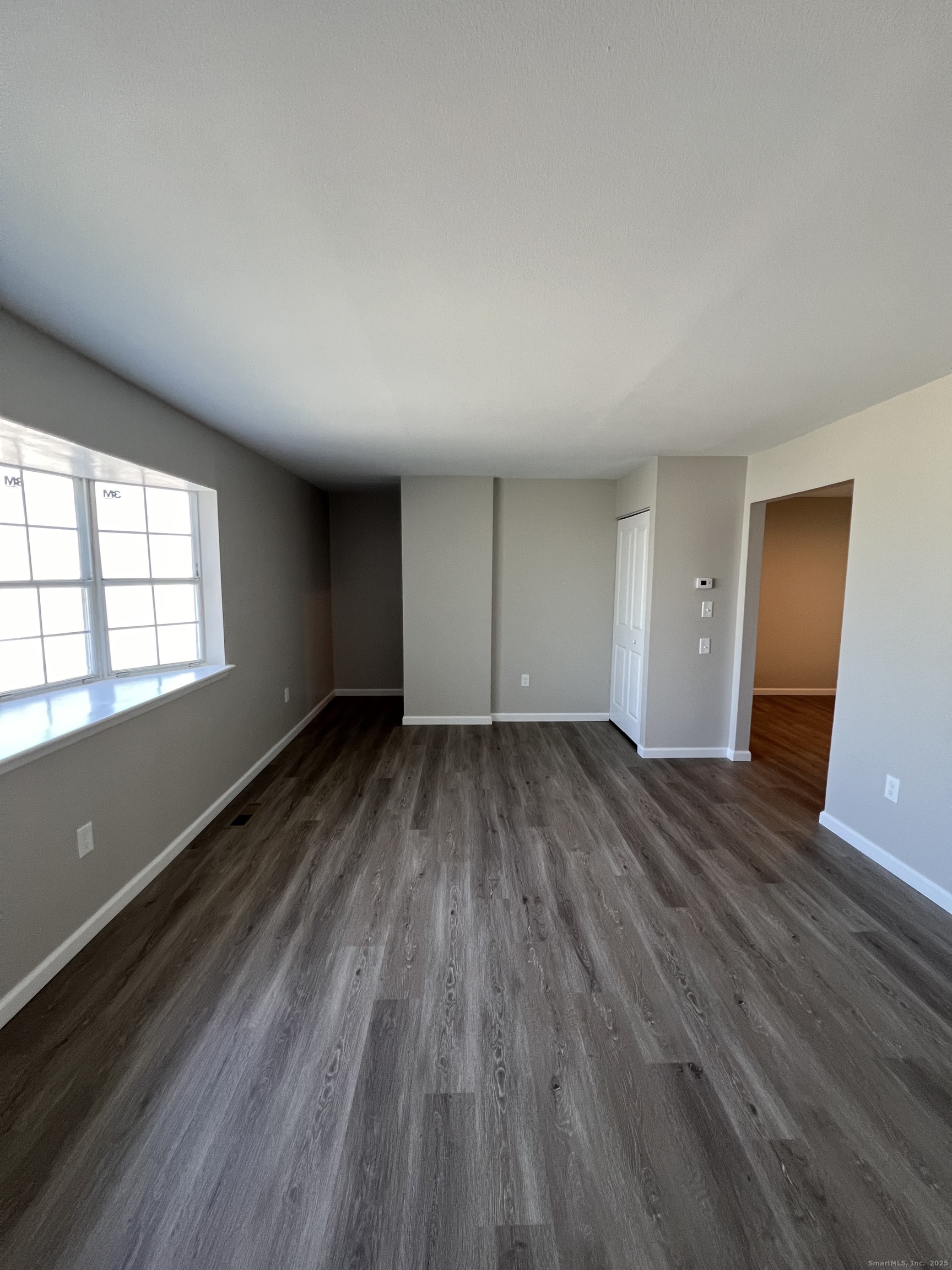 111-113 Sunset Avenue Meriden, CT 06450 - Photo 2 of 25 an empty room with wooden floor and windows