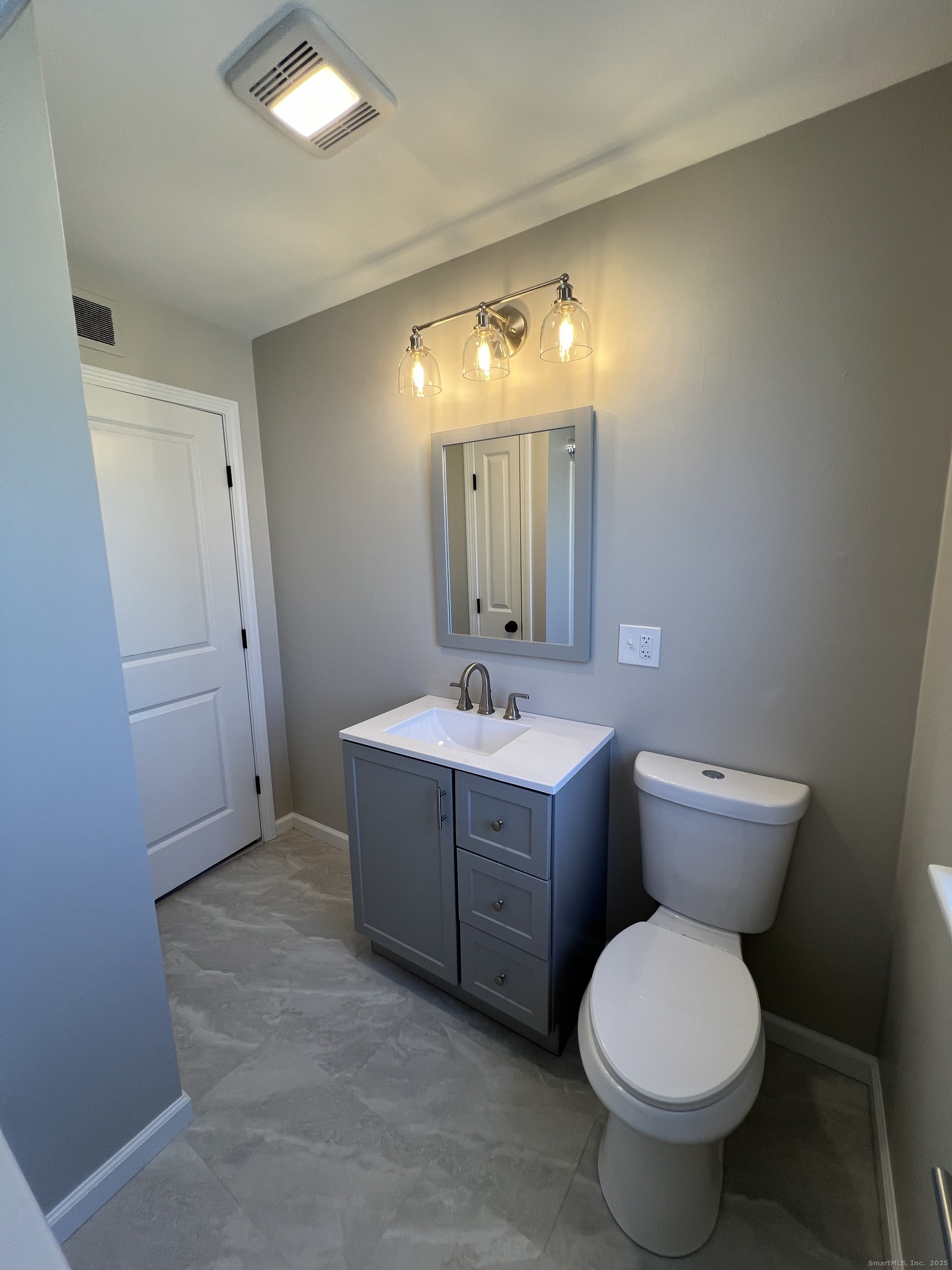 111-113 Sunset Avenue Meriden, CT 06450 - Photo 23 of 25 a bathroom with a toilet sink and mirror