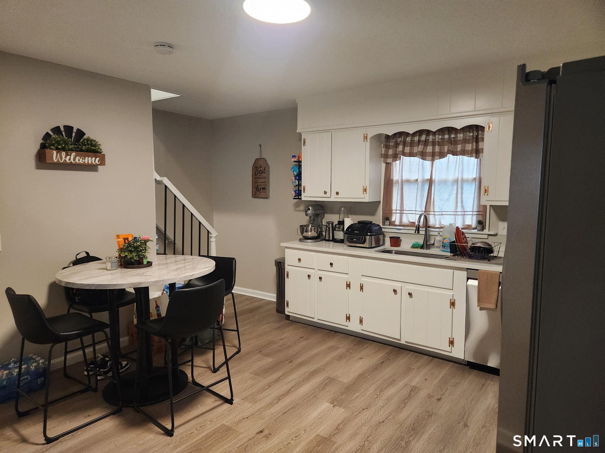111-113 Sunset Avenue Meriden, CT 06450 - Photo 3 of 25 a kitchen with stainless steel appliances a table chairs and a refrigerator
