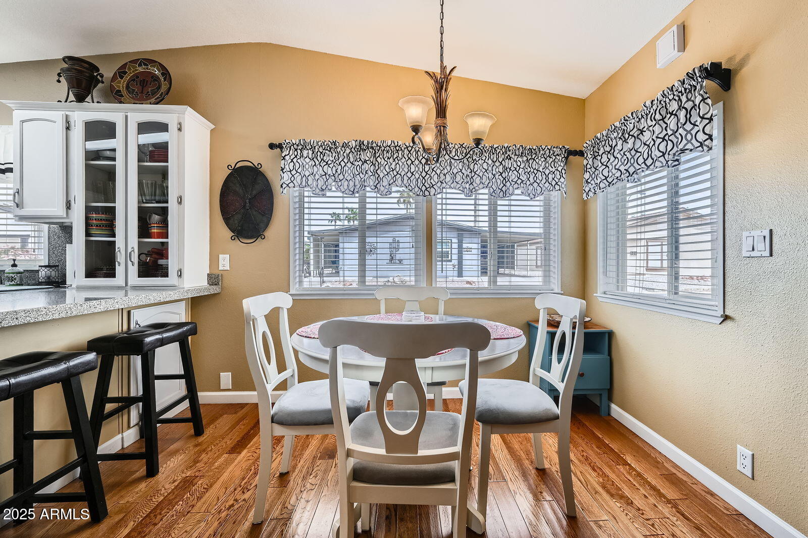 2400 East Baseline Avenue, Unit 94 Apache Junction, AZ 85119 - Photo 13 of 29 a view of a dining room with furniture a chandelier and wooden floor