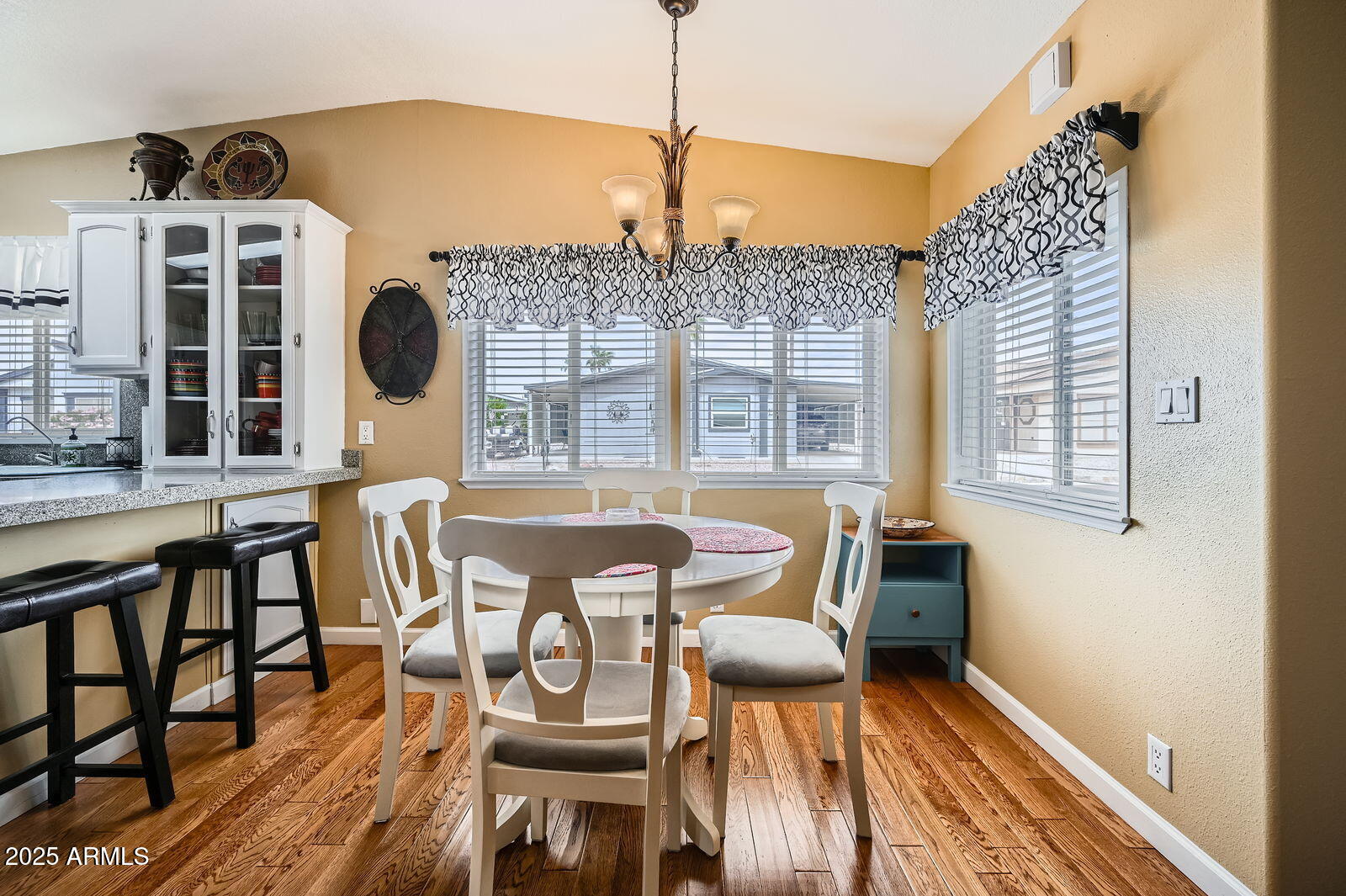2400 East Baseline Avenue, Unit 94 Apache Junction, AZ 85119 - Photo 14 of 29 a view of a dining room with furniture wooden floor and chandelier