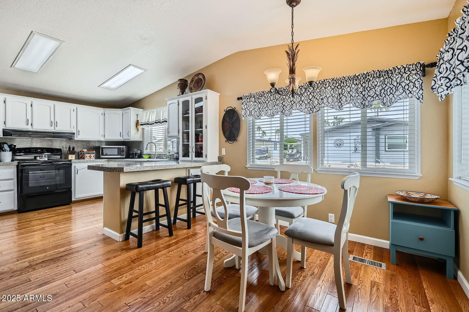 2400 East Baseline Avenue, Unit 94 Apache Junction, AZ 85119 - Photo 15 of 29 a view of a dining room with furniture window and wooden floor