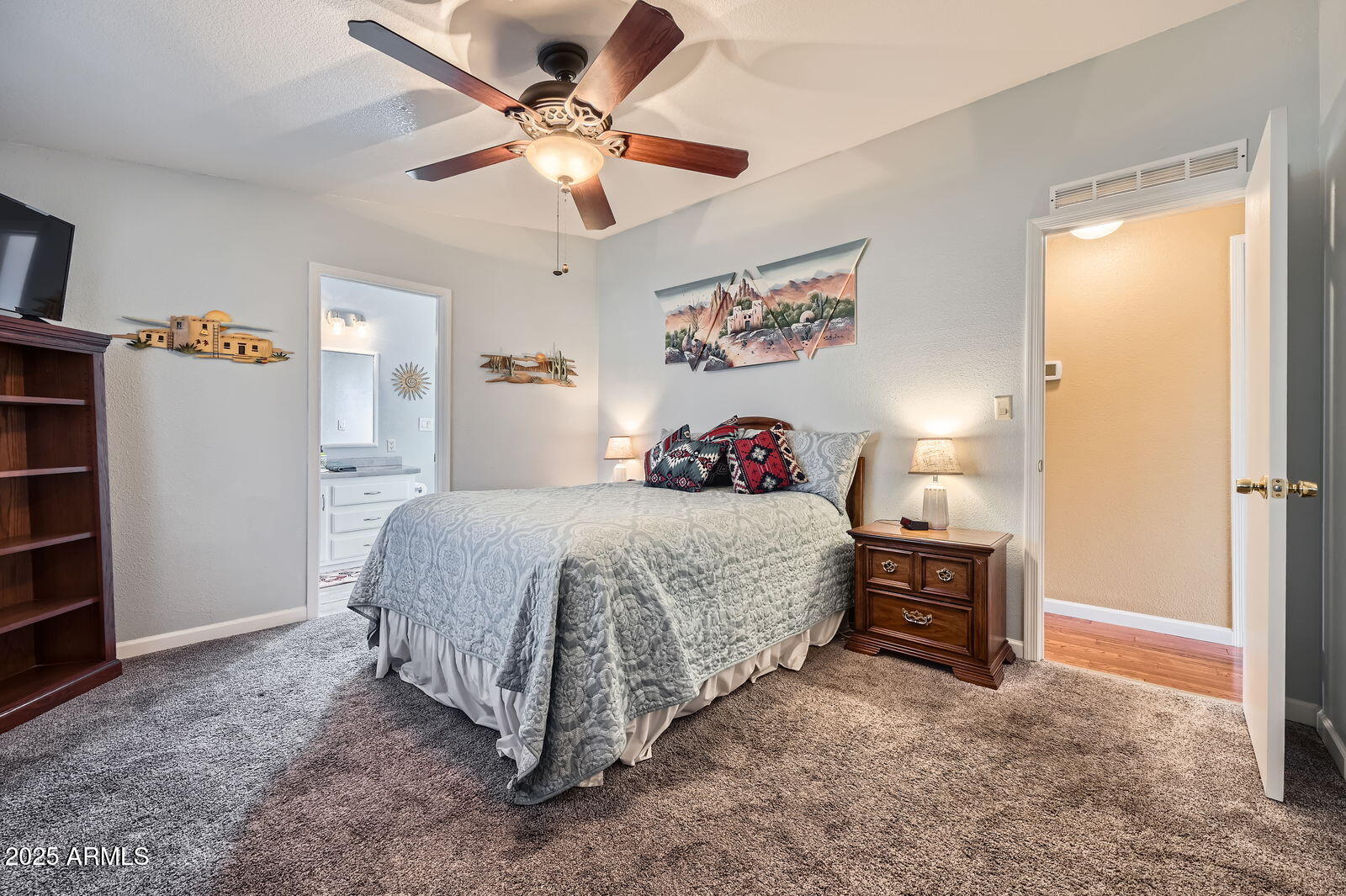 2400 East Baseline Avenue, Unit 94 Apache Junction, AZ 85119 - Photo 17 of 29 a spacious bedroom with a bed and a chandelier