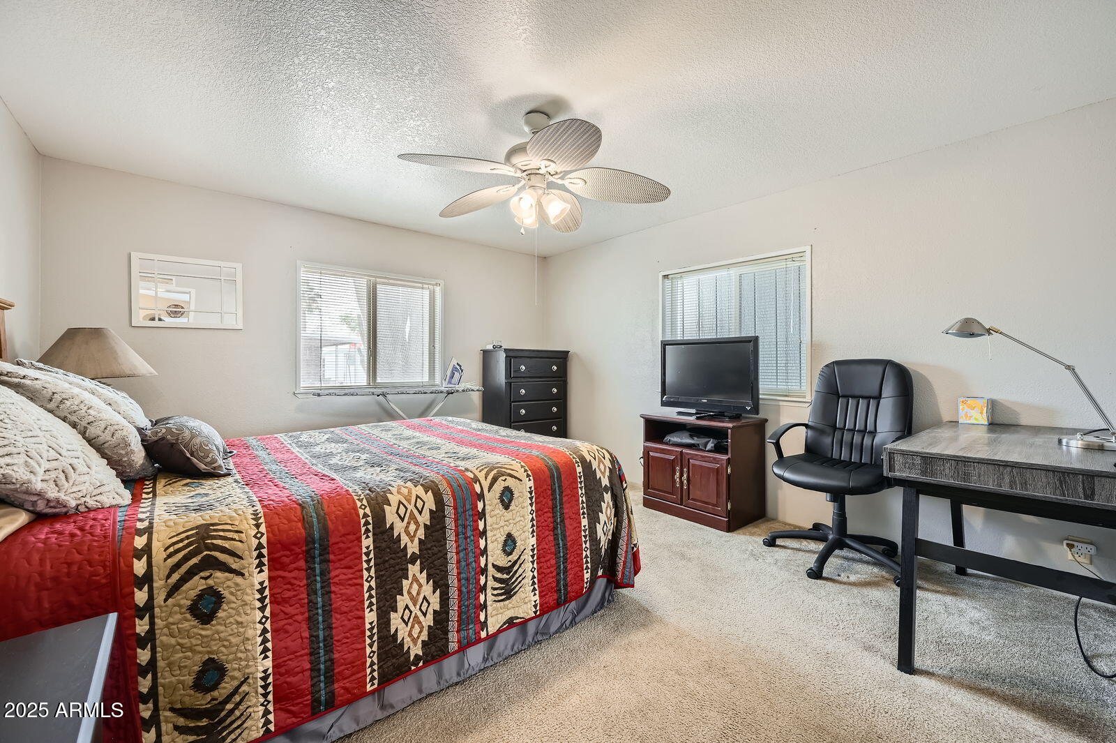 2400 East Baseline Avenue, Unit 94 Apache Junction, AZ 85119 - Photo 20 of 29 a bedroom with a bed and a flat screen tv