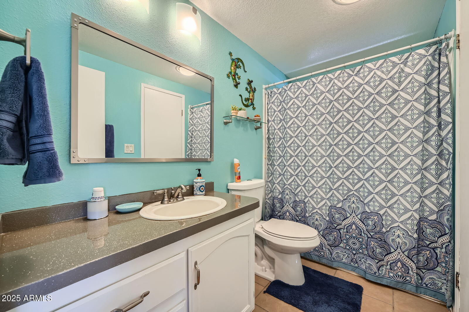 2400 East Baseline Avenue, Unit 94 Apache Junction, AZ 85119 - Photo 22 of 29 a bathroom with a granite countertop sink a toilet and a mirror