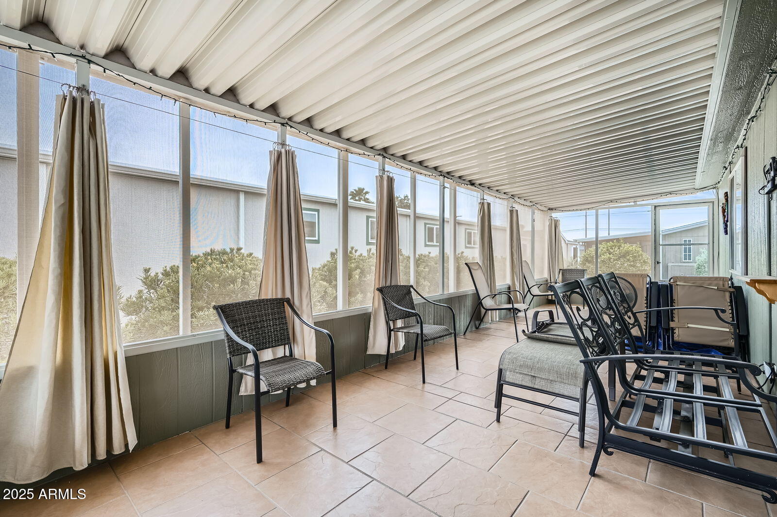 2400 East Baseline Avenue, Unit 94 Apache Junction, AZ 85119 - Photo 25 of 29 a living room with furniture a flat screen tv and large windows