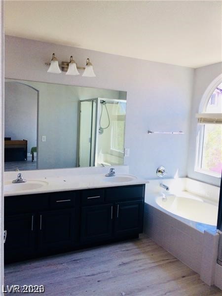8897 Houston Ridge Avenue Las Vegas, NV 89178 - Photo 8 of 12 Dual vanities complement a soaking tub, inviting serene relaxation.