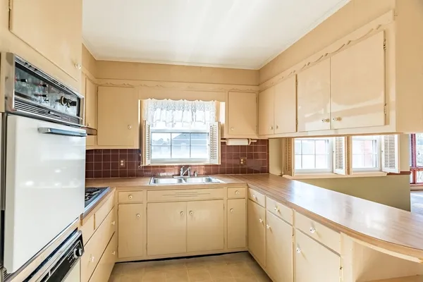 a kitchen with a sink stove and cabinets