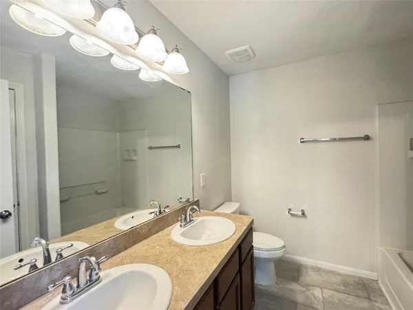 a car parked in front of a house with a yard