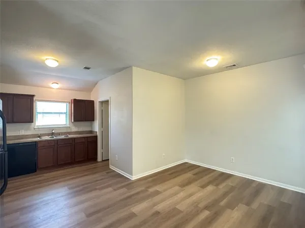 a view of a kitchen with a sink and a refrigerator