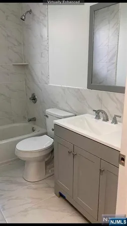 a bathroom with a sink a toilet and mirror
