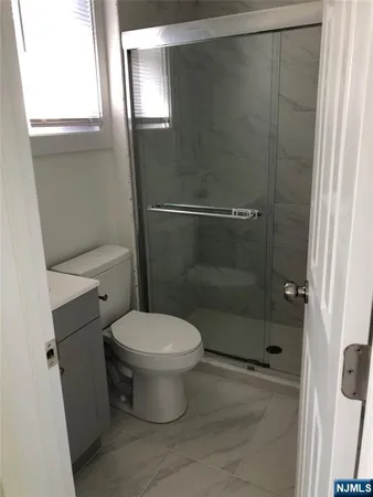 an empty room with wooden floor and entrance