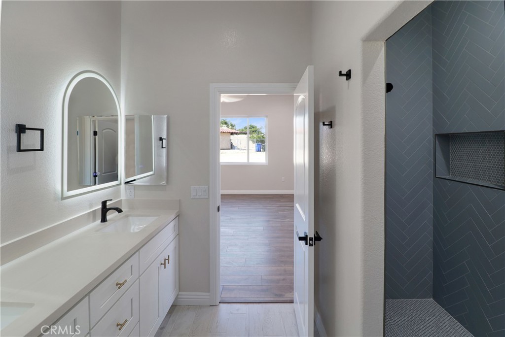 14785 Tigertail Road Apple Valley, CA 92307 - Photo 13 of 20 a bathroom with a double vanity sink and mirror