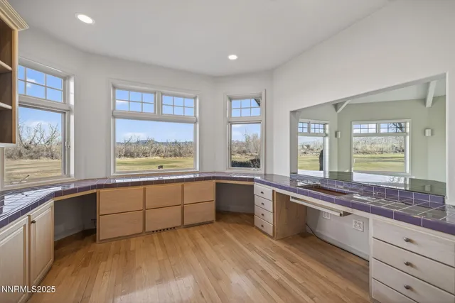 a large kitchen with stainless steel appliances granite countertop a stove and a sink
