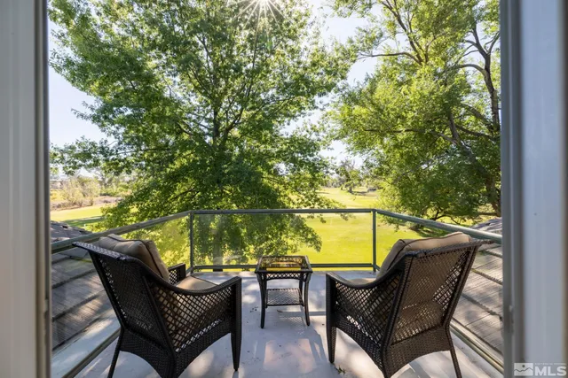 a view of a two chair and table in the balcony